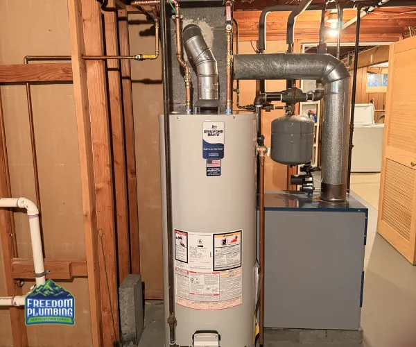 A section of copper plumbing featuring significant limescale buildup and crusting around the threaded connections and valves.